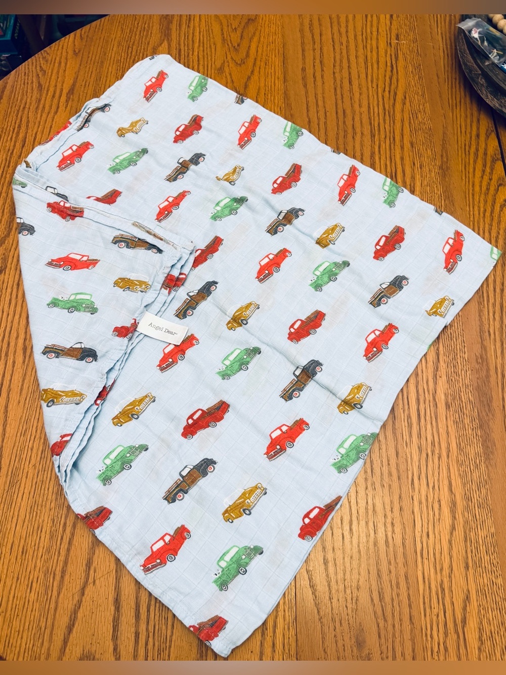 Angel Dear Light Blue Muslin Swaddle with Red, Green, Mustard, and Brown Cars